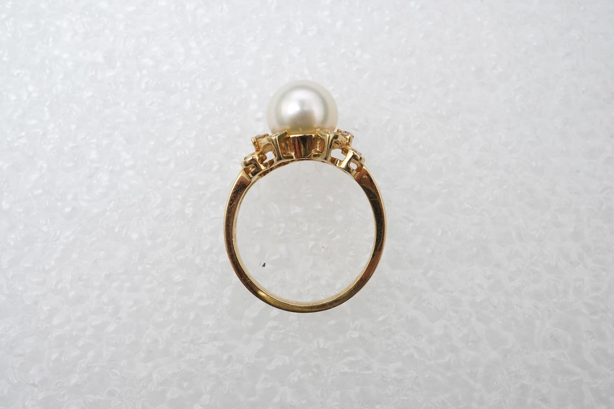 A cultured pearl and diamond ring